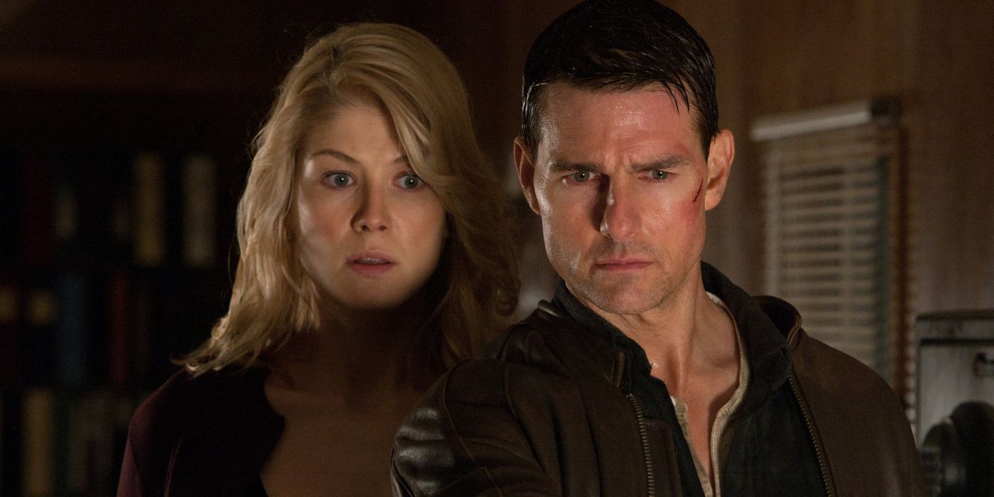 Jack Reacher (Tom Cruise) and Helen Rodin (Rosamund Pike) looking downward intensely in Jack Reacher