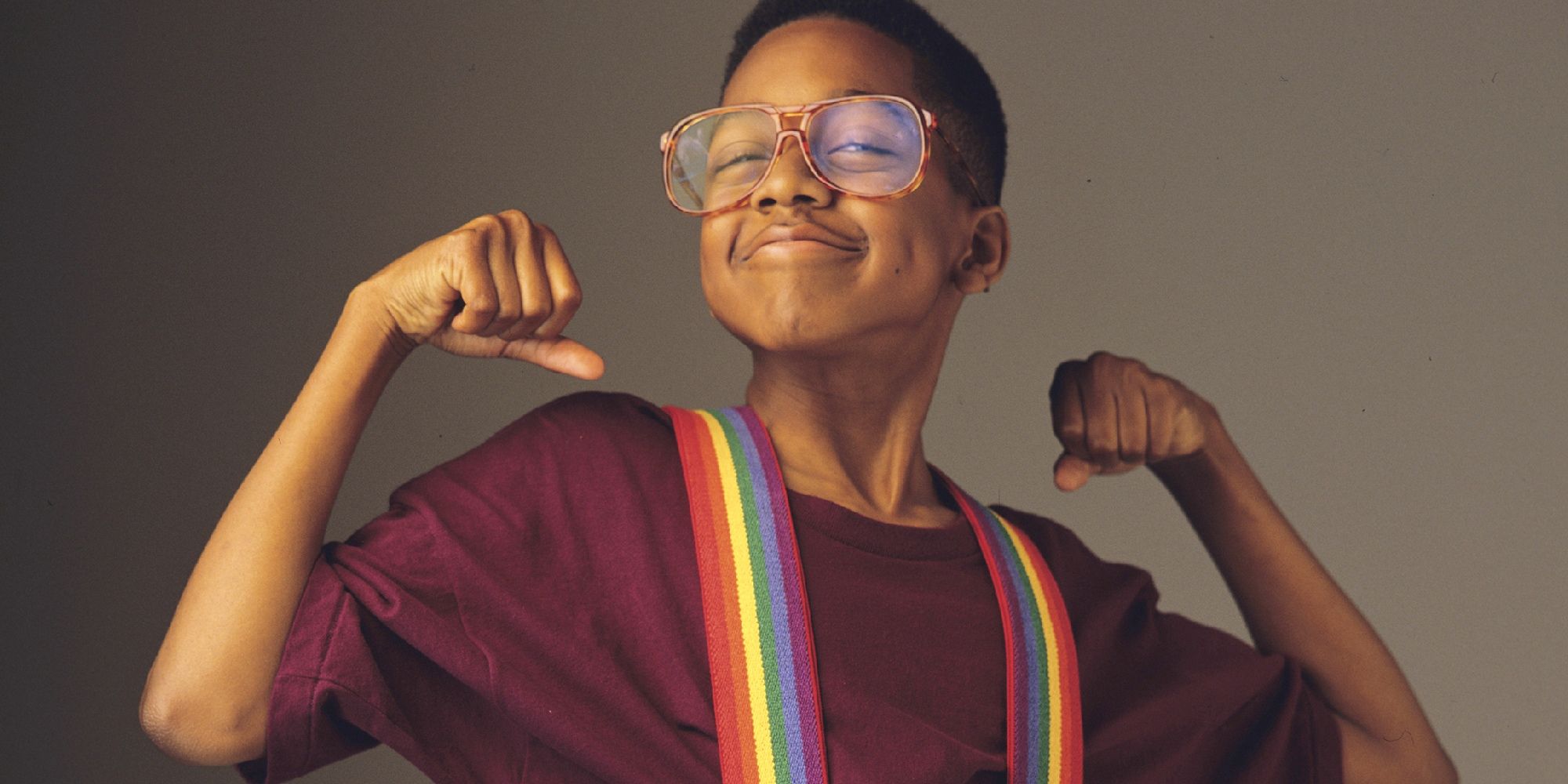 A young Jaleel White in Family Matters as Steve Urkel smiling and flexing his arms