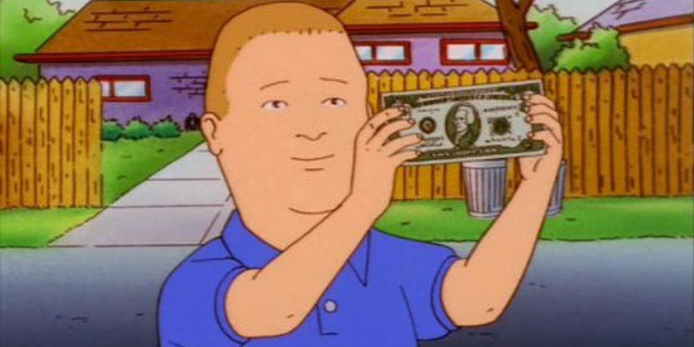 Bobby Hill holding up a dollar bill while wearing a blue shirt on a nice day.