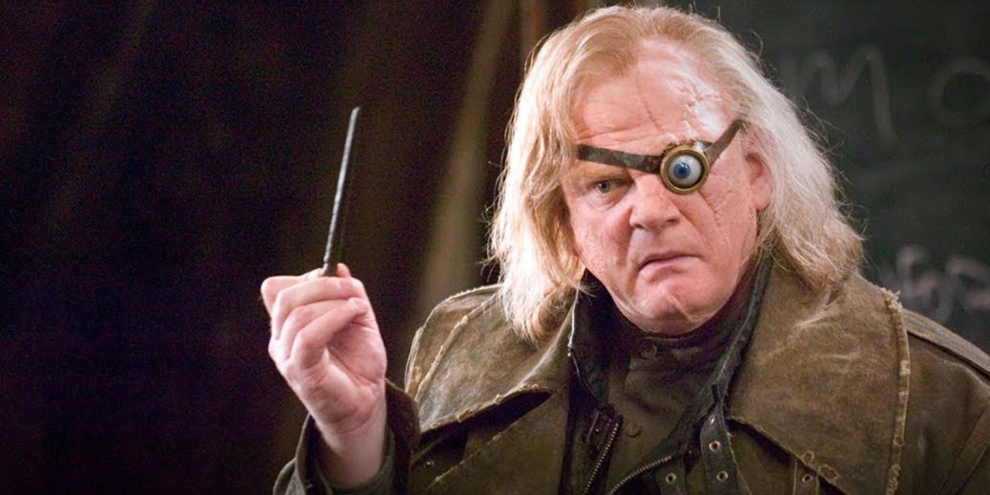 Mad Eye Moody holding up his wand in front of a chalk board in Harry Potter and the Goblet of Fire