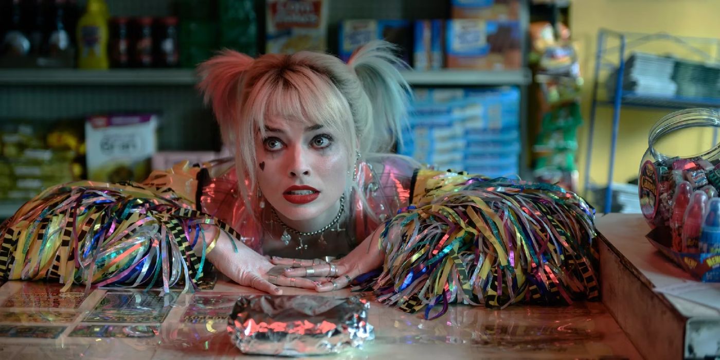 Margot Robbie as Harley Quinn with her egg sandwich looking slightly worried in Birds of Prey