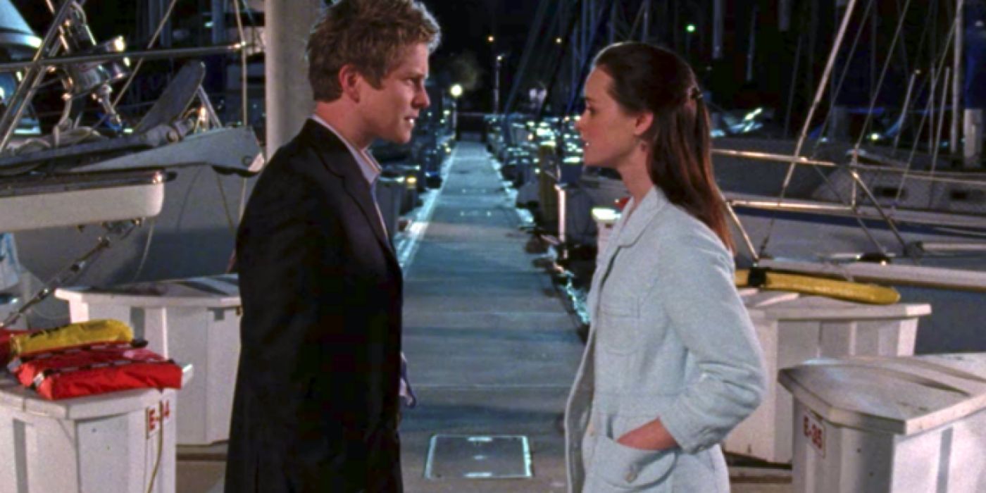 Matt Czuchry and Alexis Bledel as Logan and Rory in Gilmore Girls, talking on a pier.