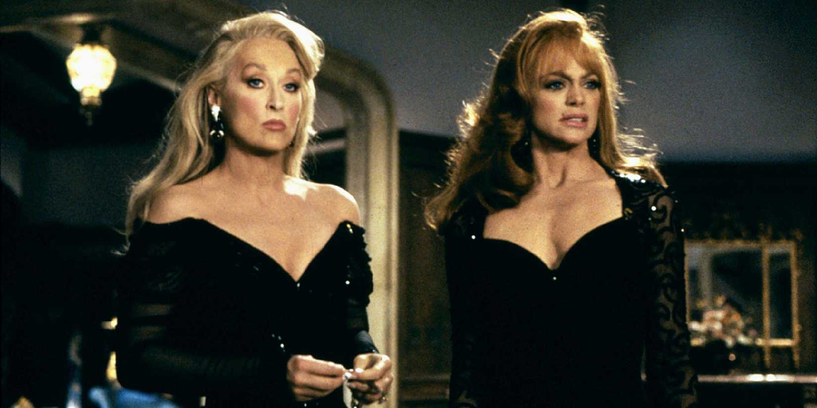 Meryl Streep and Goldie Hawn in black dresses, looking serious in Death Becomes Her