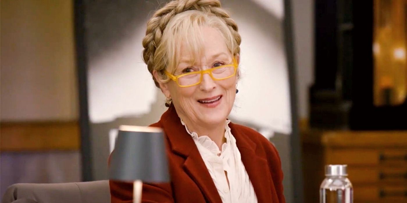 Meryl Streep as Loretta Durkin smiling, sitting down at a table read in Only Murders in the Building Season 3