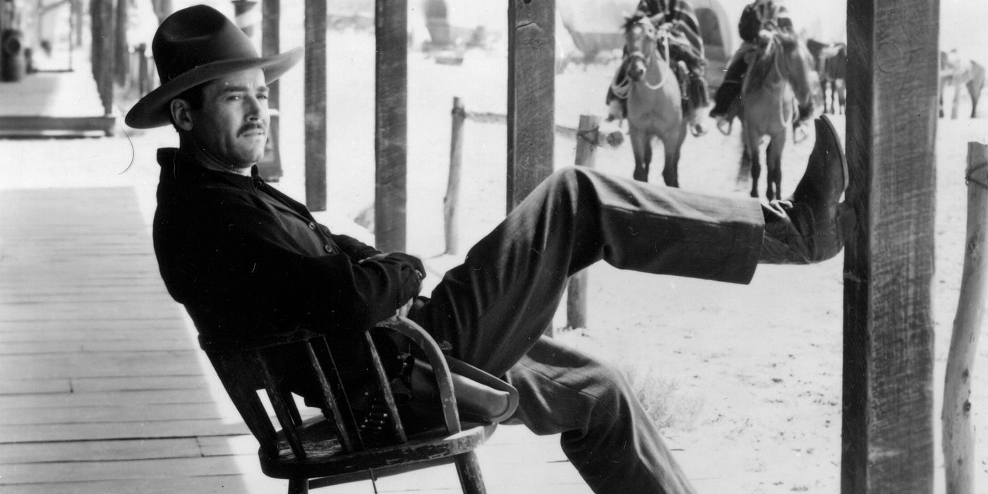 Wyatt Earp (Henry Fonda) leans in a chair with his leg on a post in My Darling Clementine