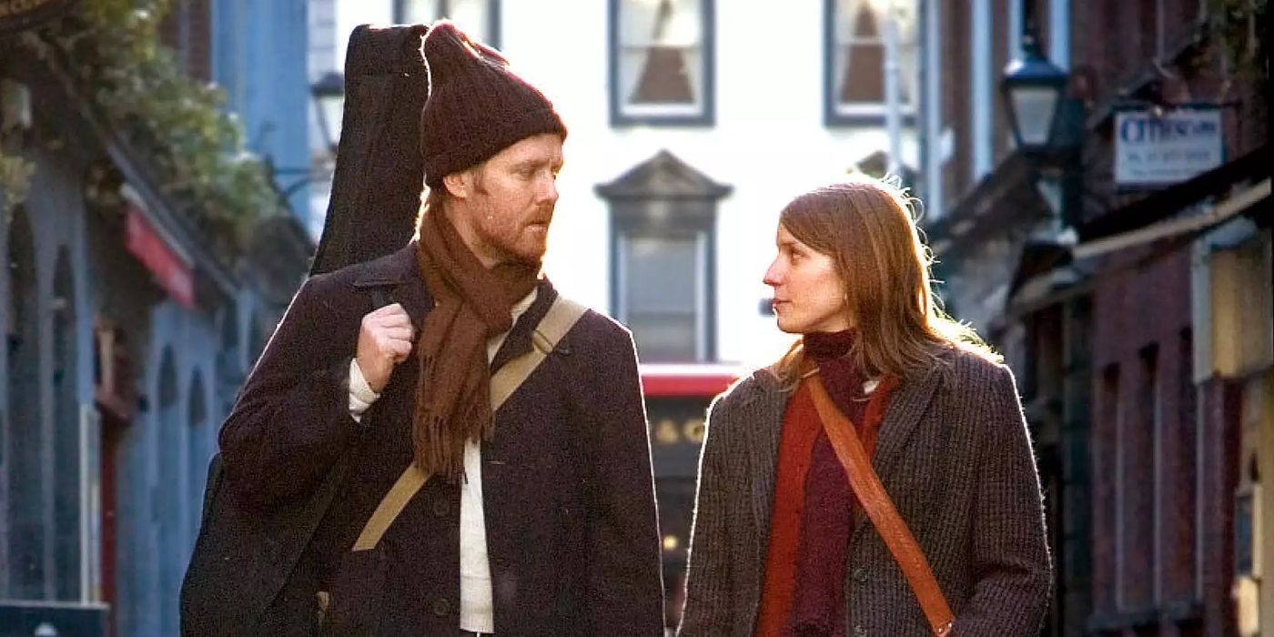 Guy (Glen Hansard) and Girl (Markéta Irglová) looking at each other as they walk down the street in the movie, 'Once.' 