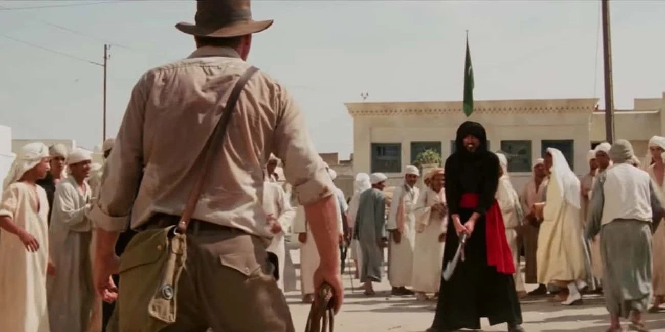 Indiana Jones faces off with a villain holding a sword in 'Raiders of the Lost Ark'