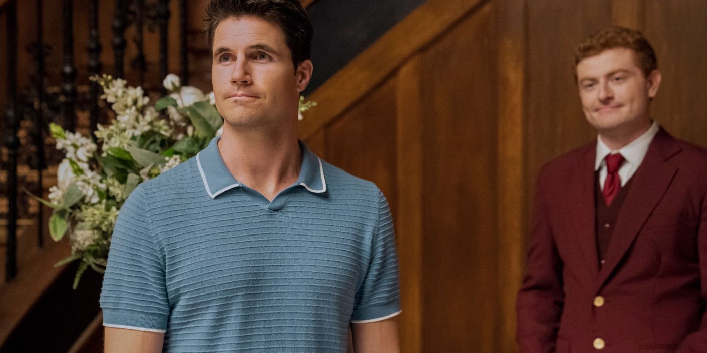 Nathan (Robbie Amell) and A.I. Guy (Owen Daniels) standing in the Lakeview lobby in Upload Season 3