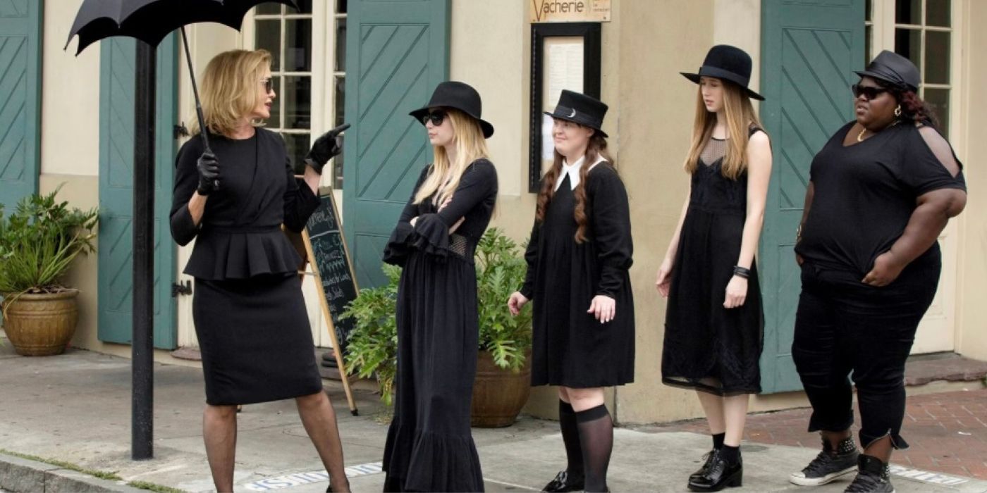 Fiona Goode leading a line of witches dressed in black in American Horror Story: Coven