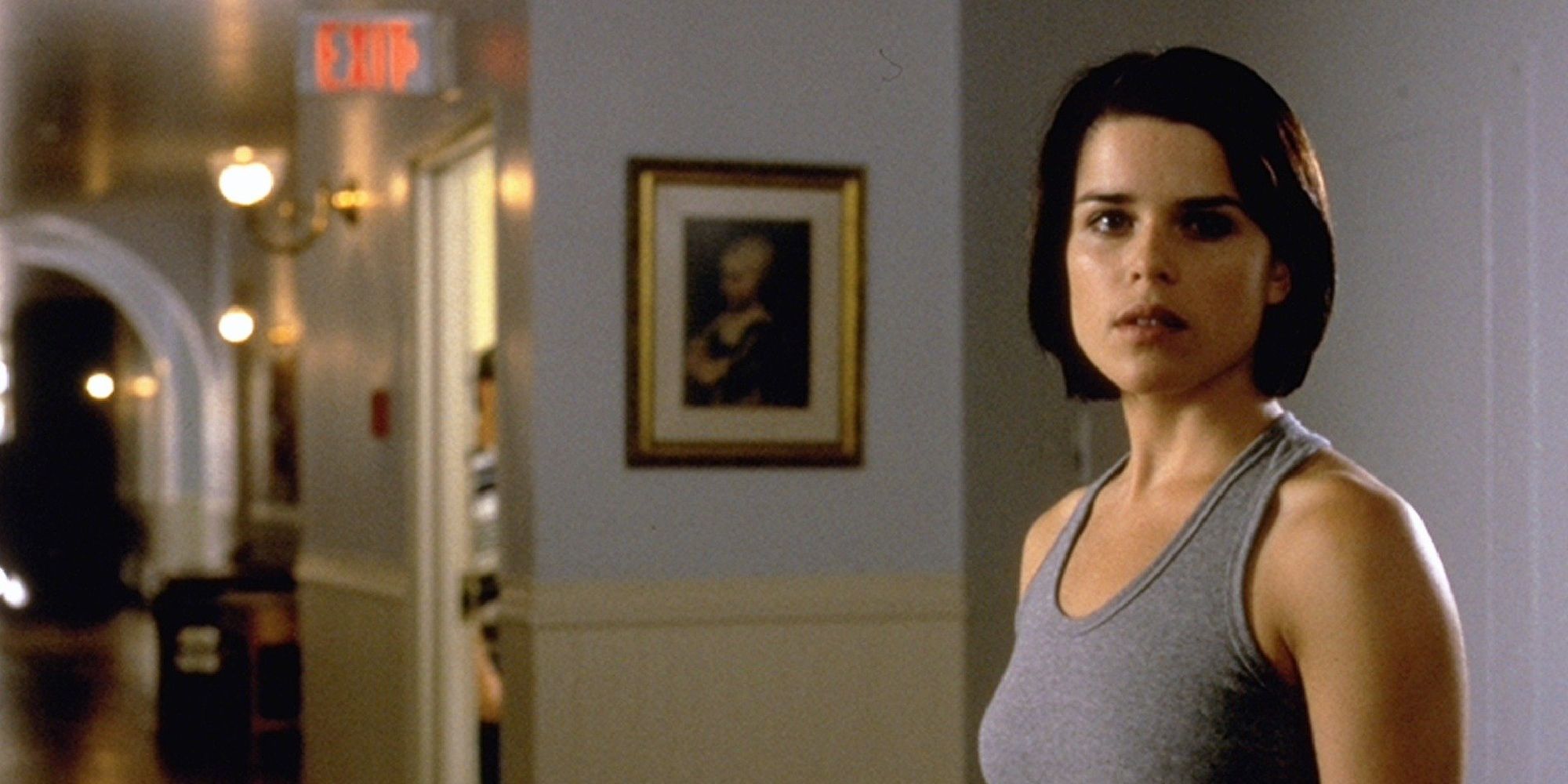 Sidney Prescott stands alone in a foyer in Scream 2