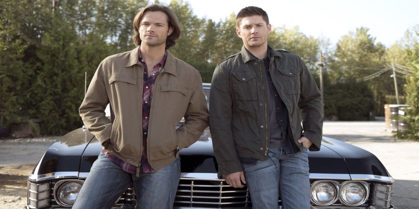 Sam And Dean stand in front of their impala in CW's Supernatural