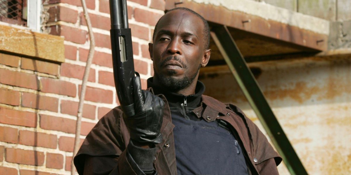 Michael K. Williams as Omar in The Wire holding a gun and looking serious