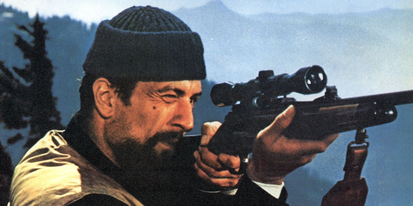 Robert De Niro as Michael Vronsky aiming a rifle at somethign off-camera in The Deer Hunter.