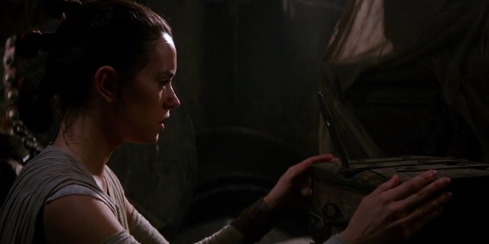 Rey (Daisy Ridley) finds Anakin and Luke's lightsaber