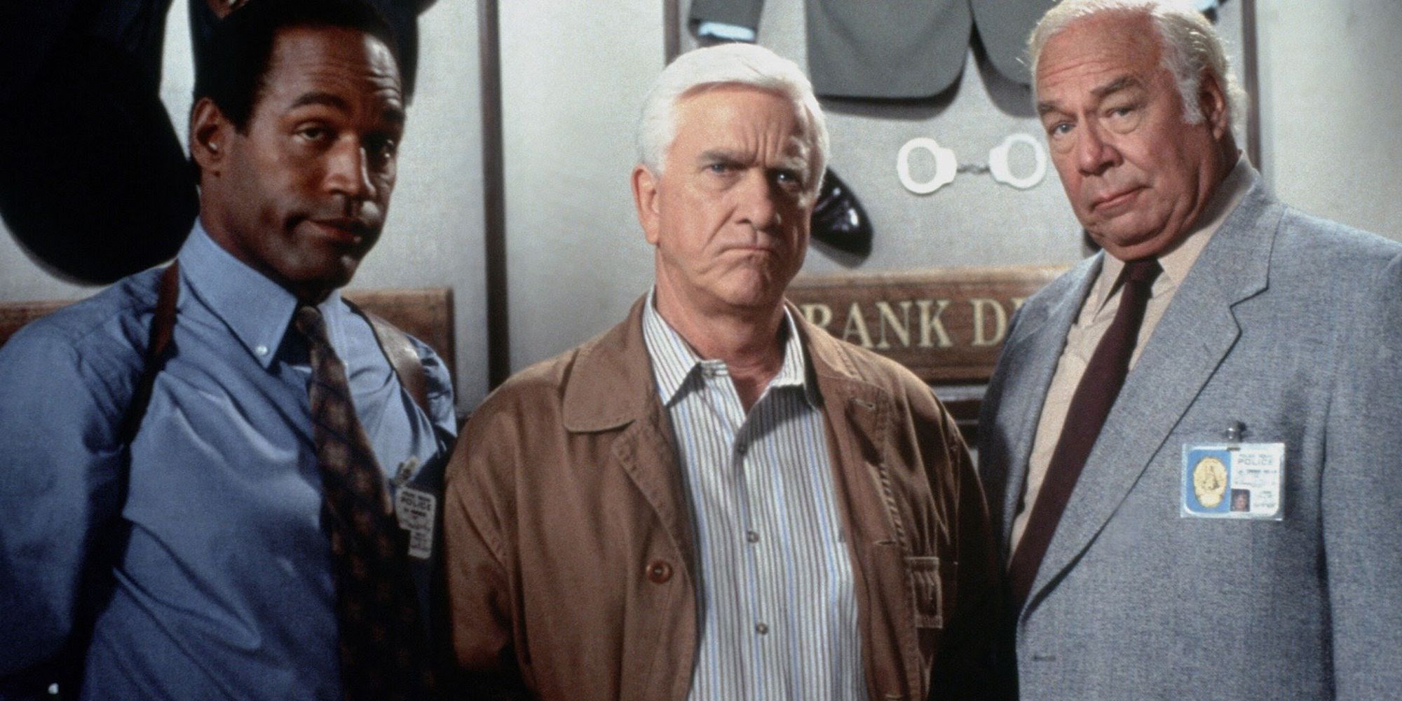 close up of Nordberg (OJ Simpson), Frank Drebin (Leslie Nielsen) and Ed Holden (George Kennedy) from The Naked Gun
