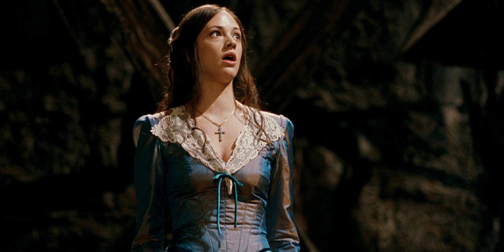 A woman in a period dress sings in a cave in The Phantom of the Opera (1998).