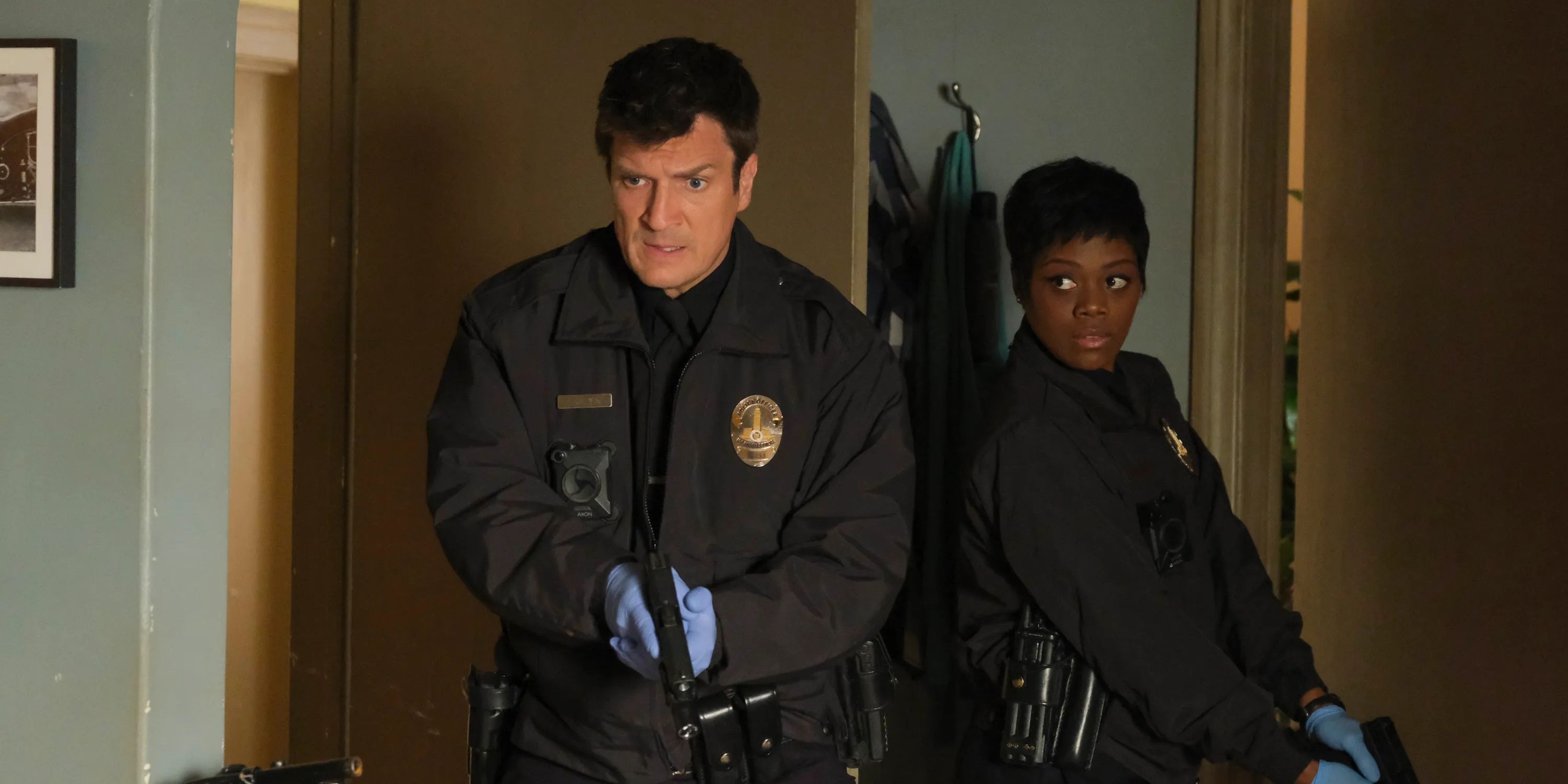 Nolan and Bishop (Nathan Fillion and Afton Williamson) with their guns drawn in The Rookie