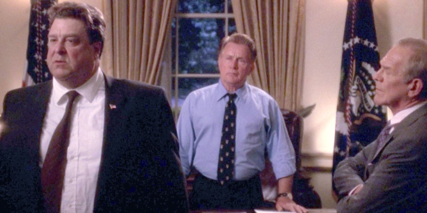 Three man standing in the Oval Office in a scene from The West Wing.