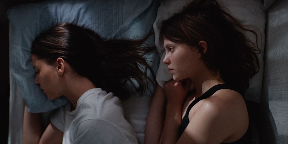Still from 'Thelma' of Thelma and Anja laying in bed.
