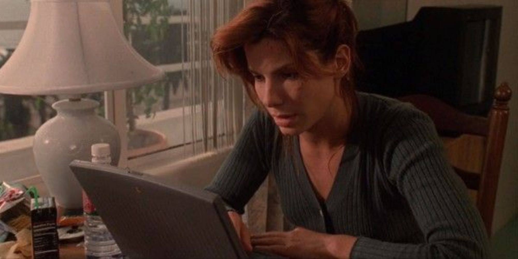 Sandra Bullock looks at a laptop