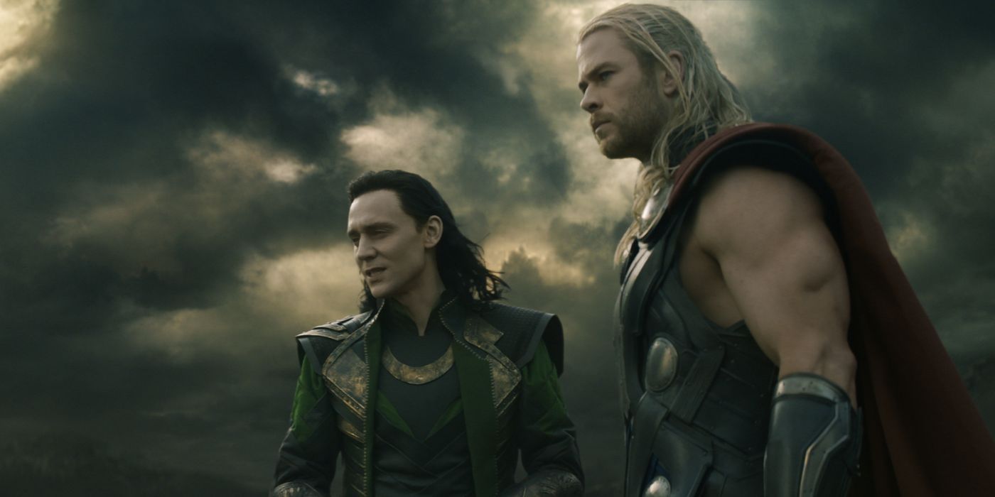 Tom Hiddleston and Chris Hemsworth as Loki and Thor looking into the distance in Thor: The Dark World.