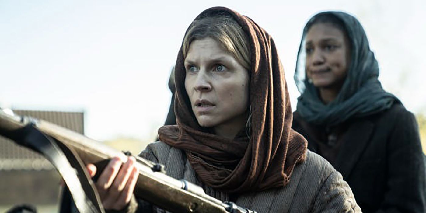 Isabelle with a scarf over her head holding a rifle, Sylvie behind here in a scene from The Walking Dead: Daryl Dixon.