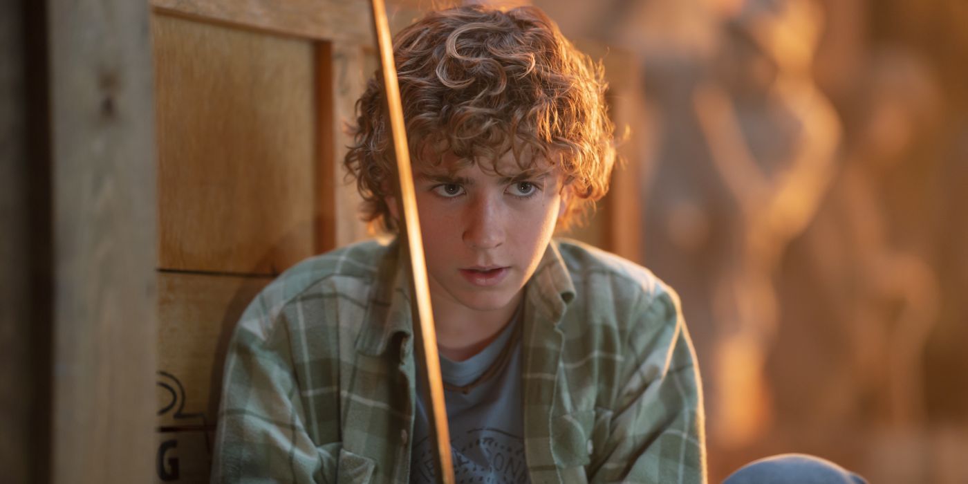 Percy (Walker Scobell) holds his sword Riptide sword in Percy Jackson and the Olympians