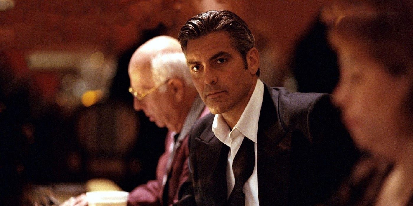 Danny Ocean (George Clooney) sitting at a betting table in Ocean's Eleven