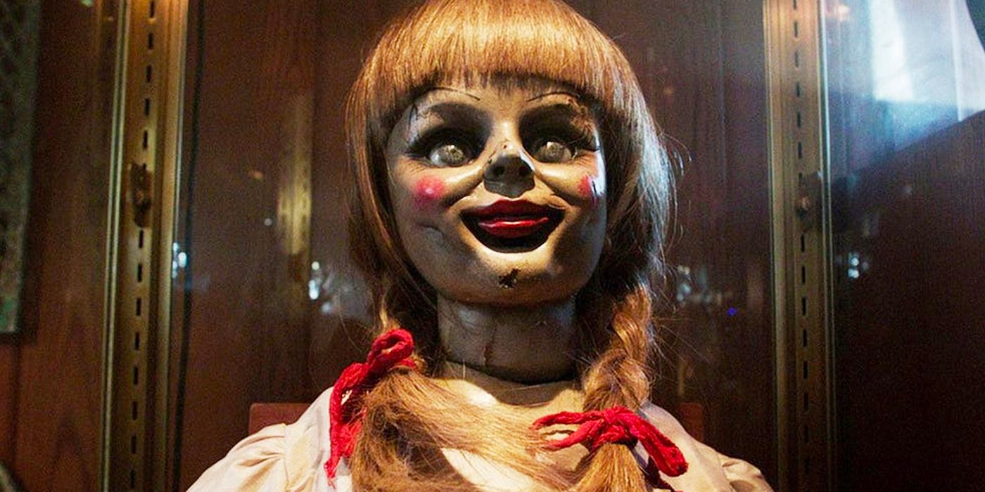 A close-up of the possessed Annabelle doll smiling in Annabelle