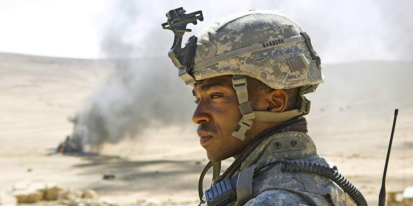 Anthony Mackie as J. T. Sanborn looking pensive while smoke blows in the background in The Hurt Locker