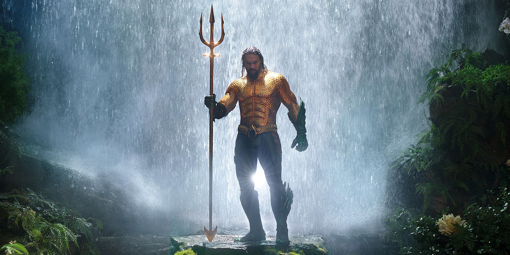 Aquaman standing in front of a waterfall holding his trident in Aquaman and the Lost Kingdom
