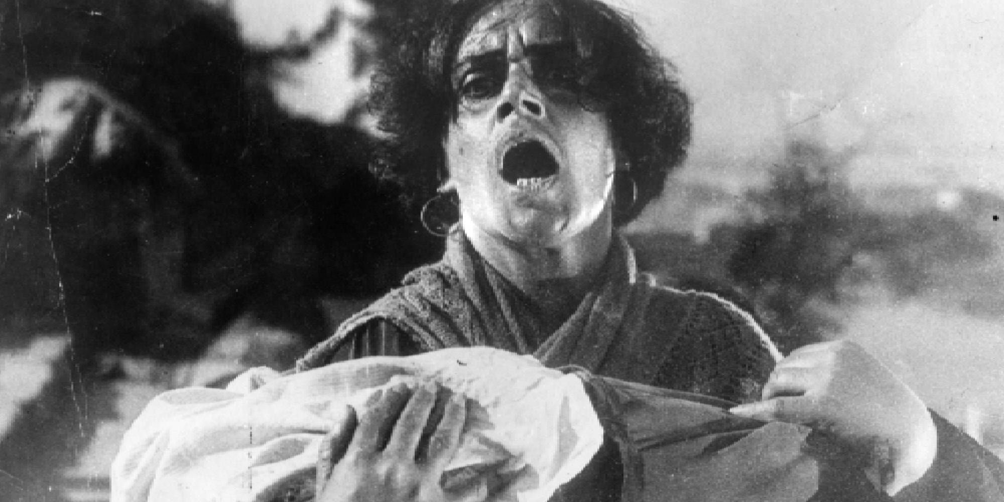 A shot of a man screaming while holding a child in his arms in Battleship Potemkin.