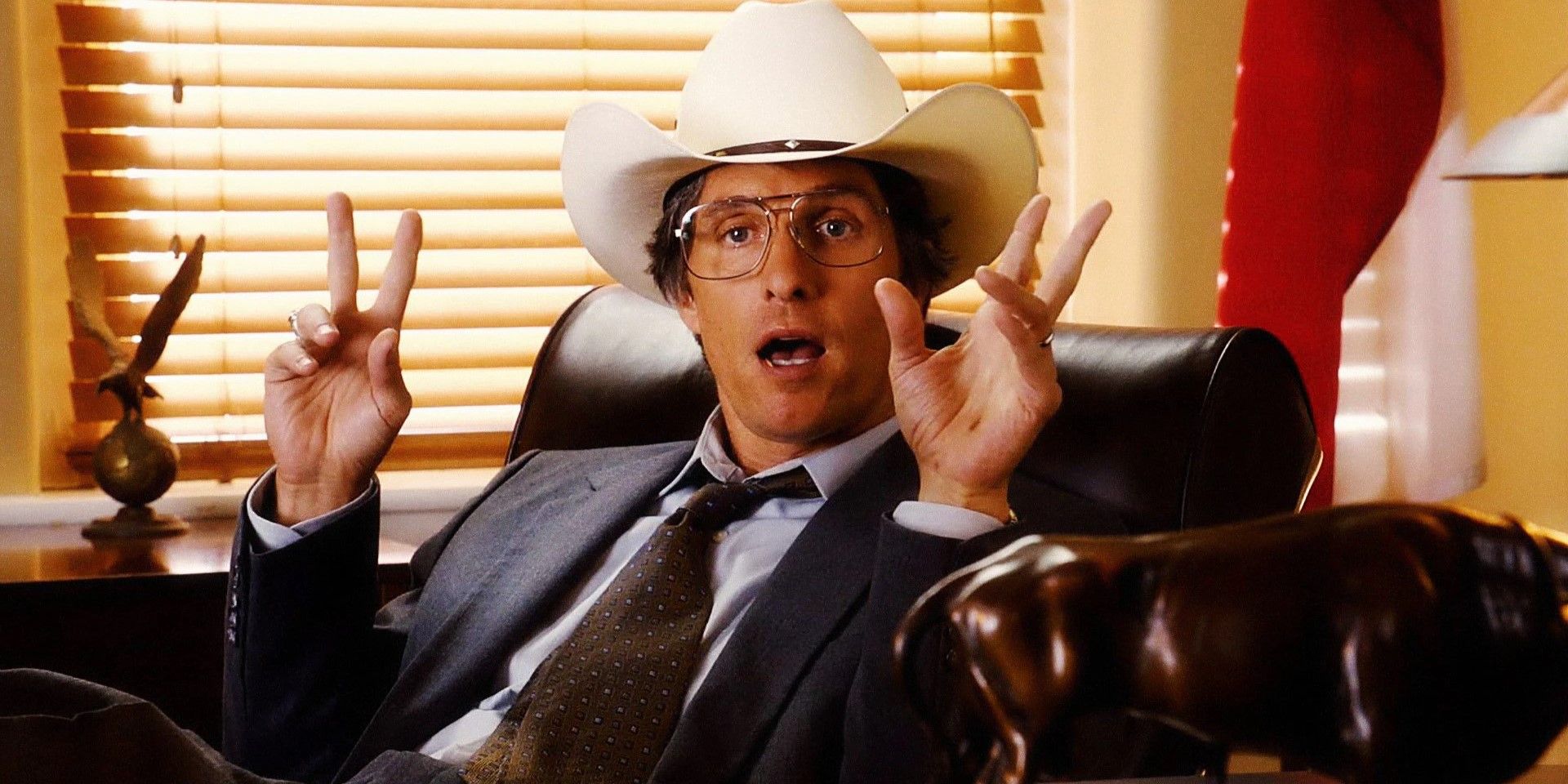 Matthew McConaughey at a desk in a cowboy hat in 'Bernie'