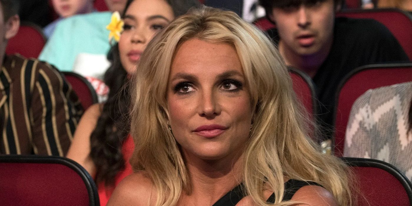 Britney Spears is seated at an awards show watching tribute performances.