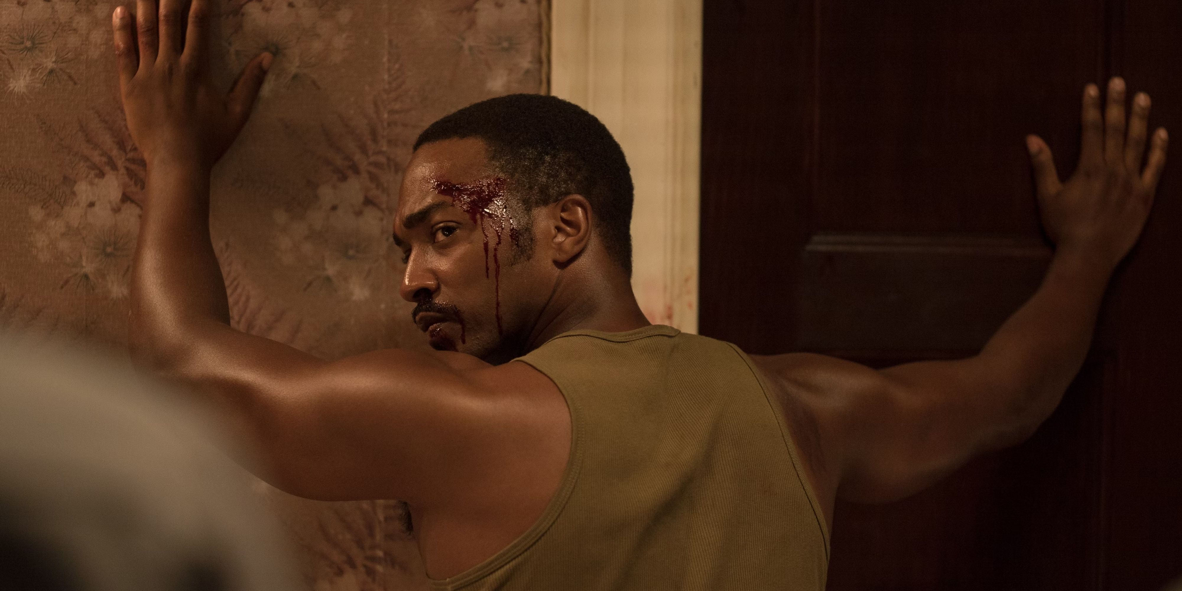Anthony Mackie as Karl Greene with his hands against a wall turning around in Detroit