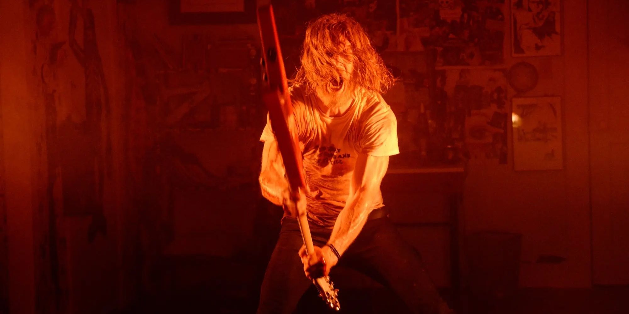 Ethan Embry wielding a guitar like an axe in The Devil's Candy