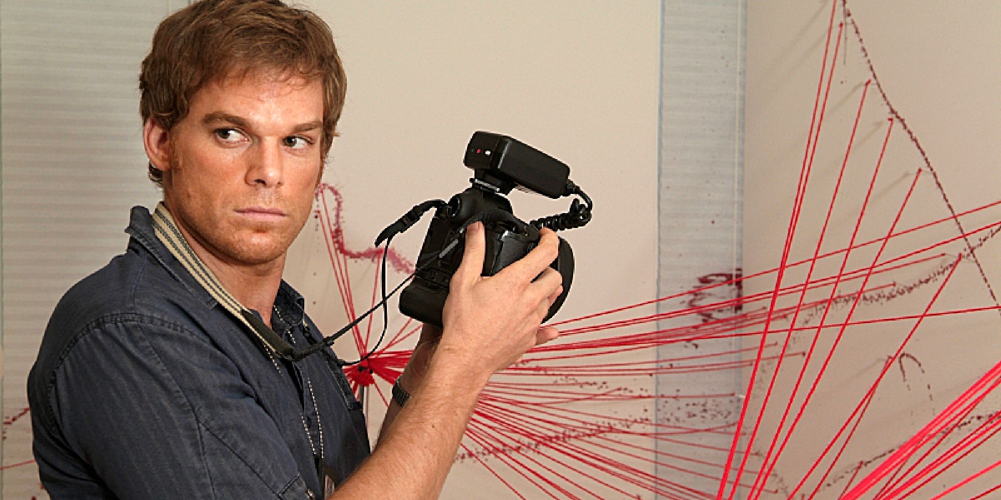 Dexter Morgan (Michael C. Hall) holds a camera on 'Dexter'