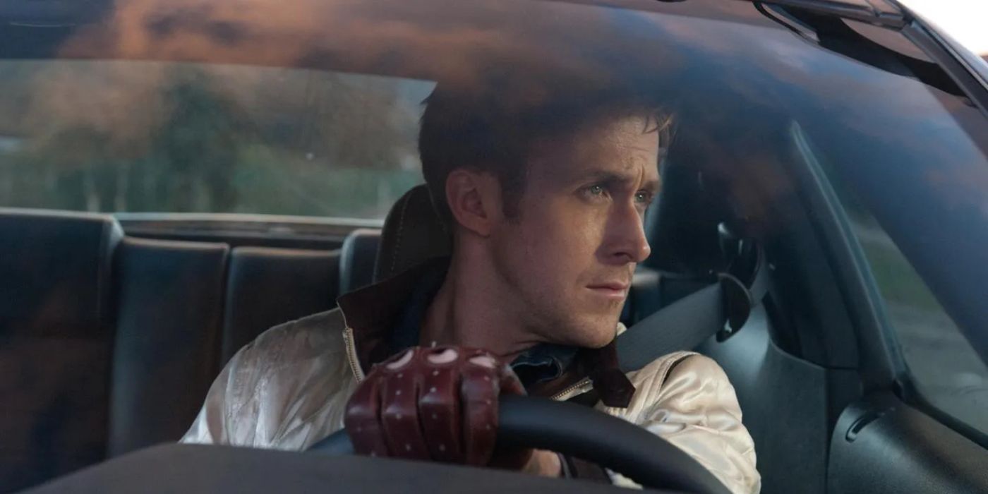 Ryan Gosling as the driver behind the wheel of a car and looking to his left in the film Drive (2011)
