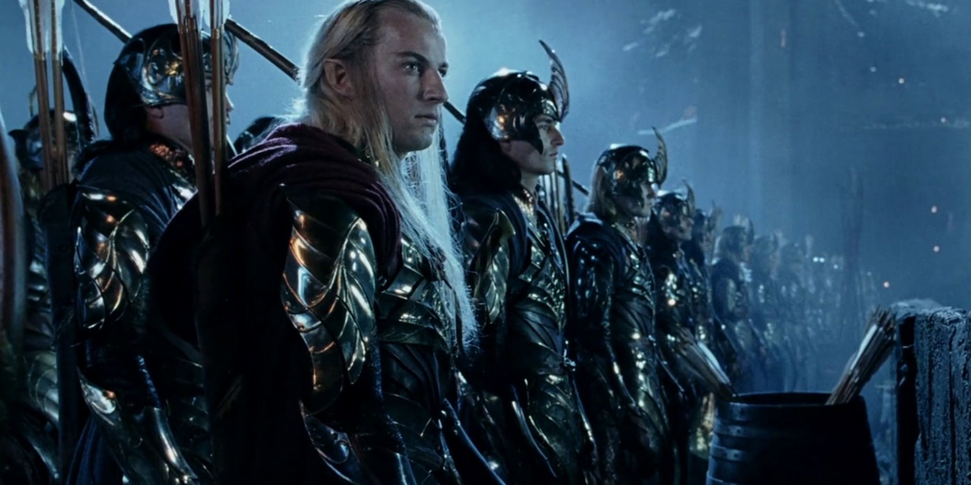 Haldir (Craig Parker) and the elves of Lorien stand in line at night while looking ahead in 'The Lord of the Rings.'