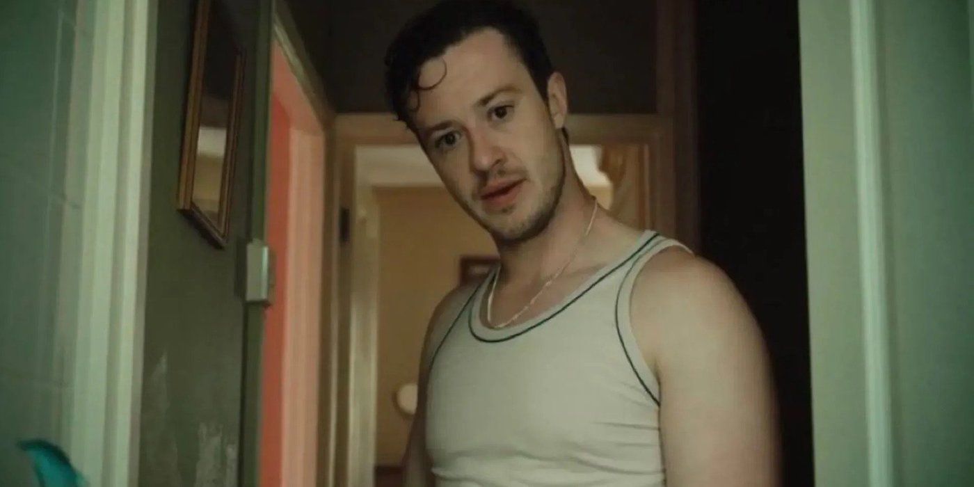 Joseph Quinn as Michael standing in a hallway in Hoard