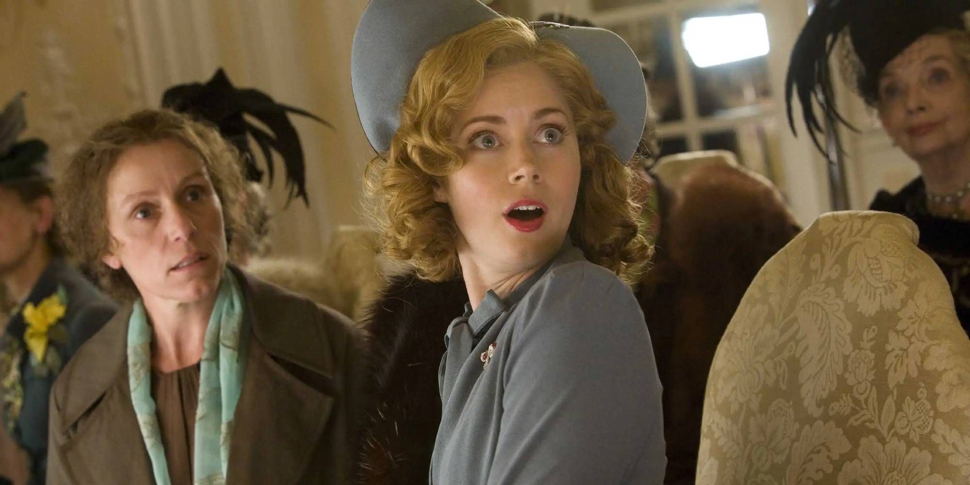 Frances McDormand and Amy Adams looking shocked as Miss Guinevere and Delysia Lafosse in Miss Pettigrew Lives for a Day.