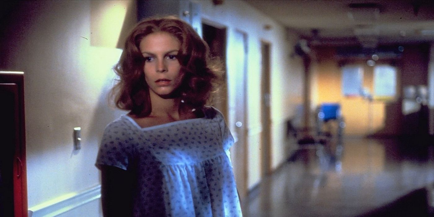 Laurie Strode, played by Jamie Lee Curtis, stands in a hospital hallway in 'Halloween II'.