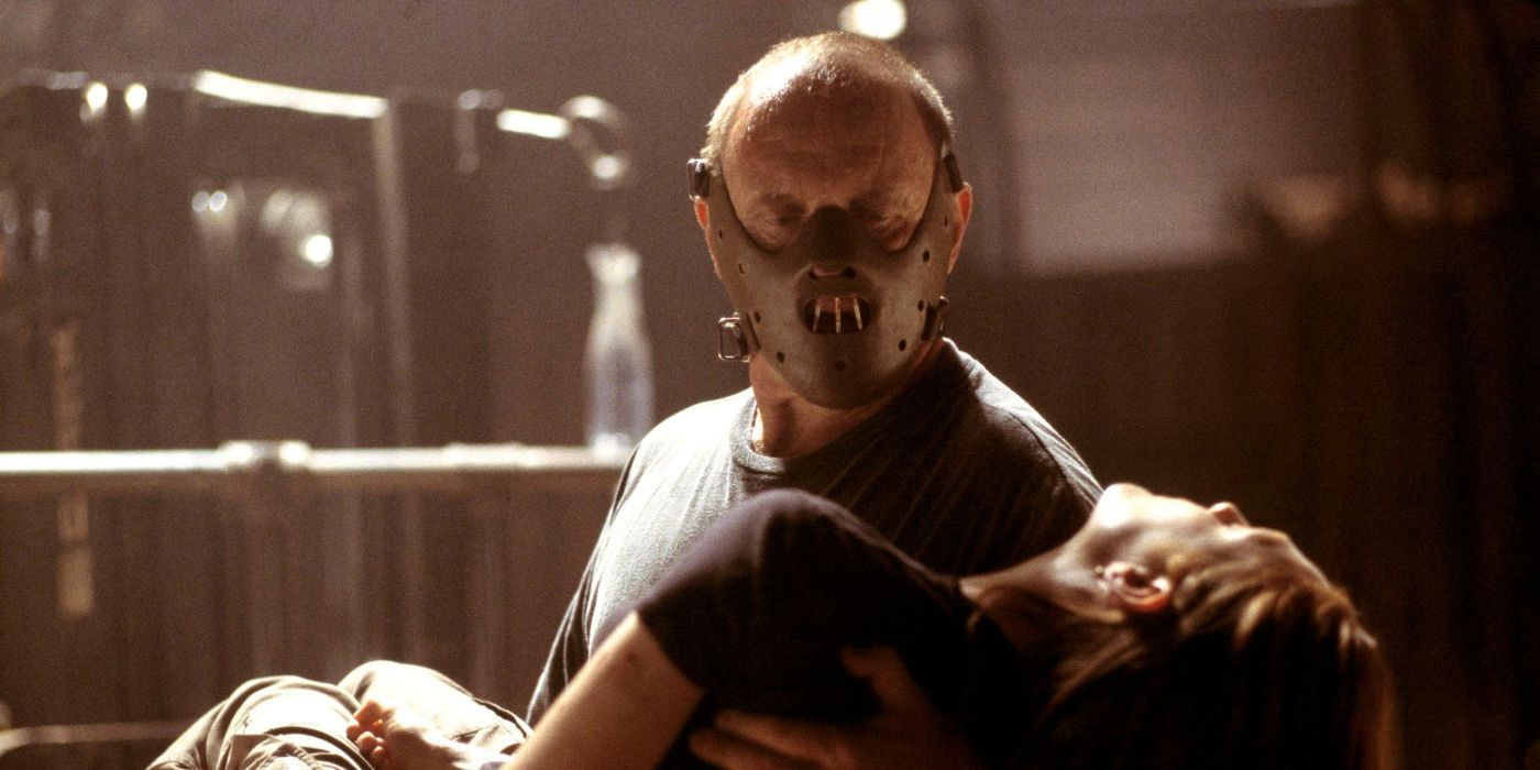 Anthony Hopkins as Hannibal wearing a mask holding a girl in Hannibal (2001)
