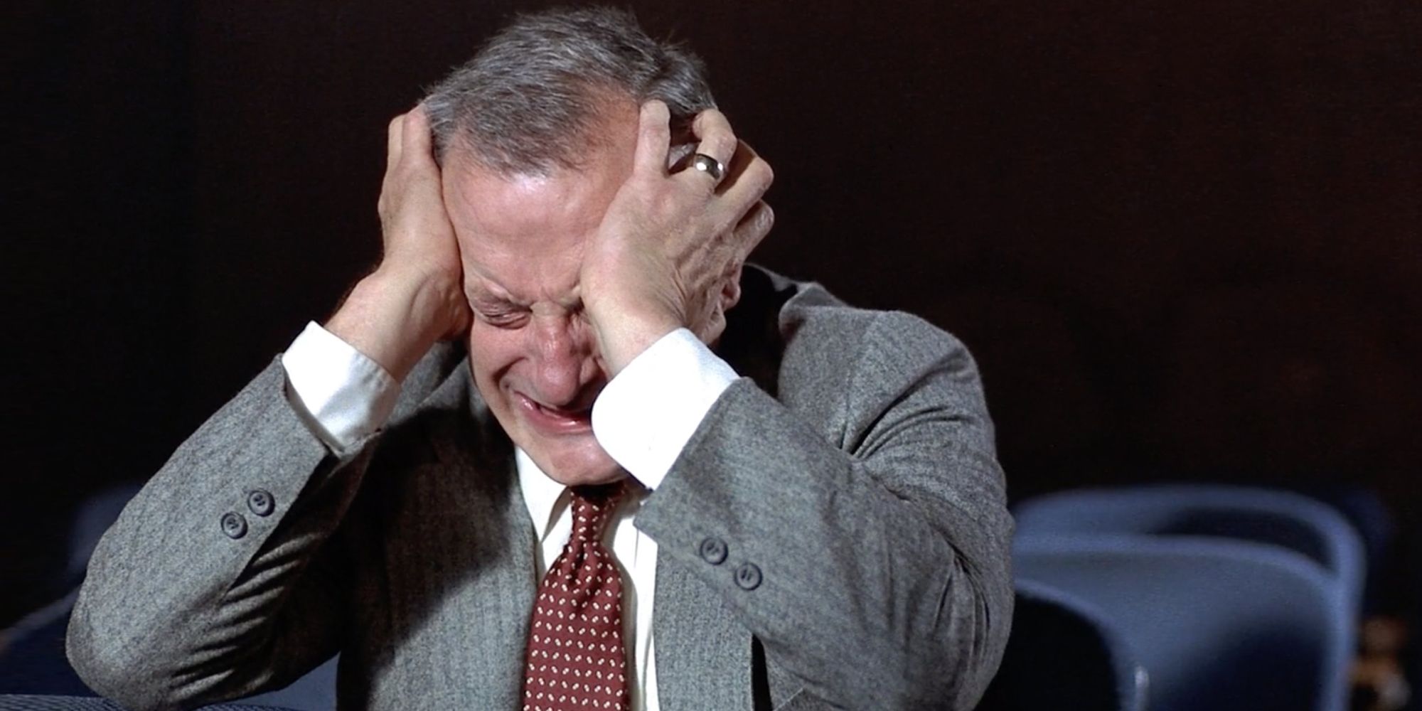 George Scott holds his head while panicking in Hardcore