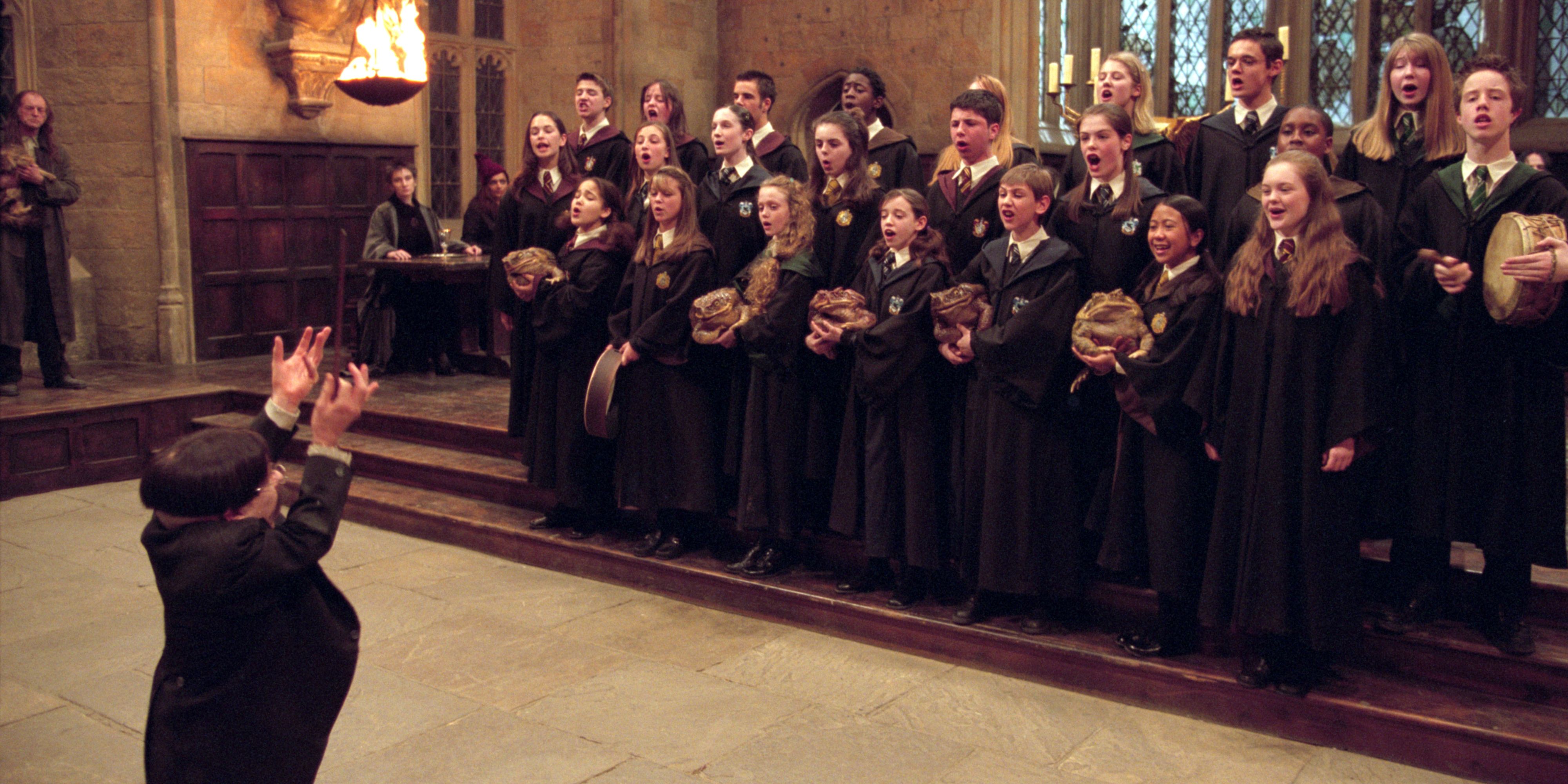 Professor Flitwick (Warwick Davis) directing the Hogwarts choir