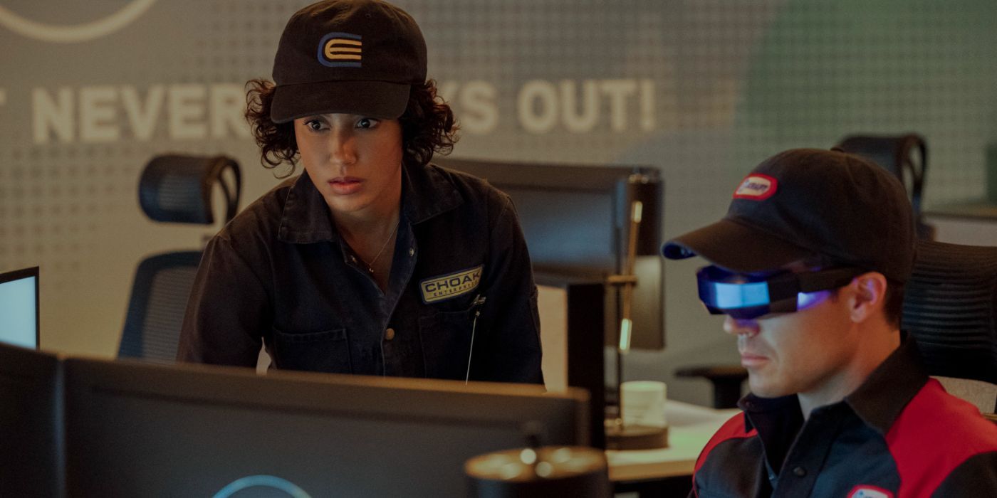 Nora (Andy Allo) looks at something on a computer in Upload Season 3