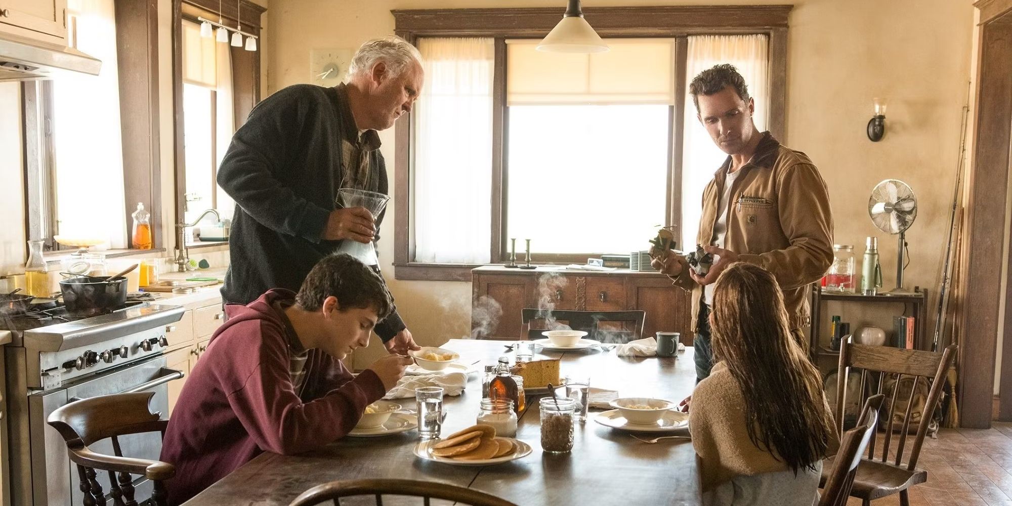 Donald, Coop, Tom, and Murph talk in the kitchen in Interstellar