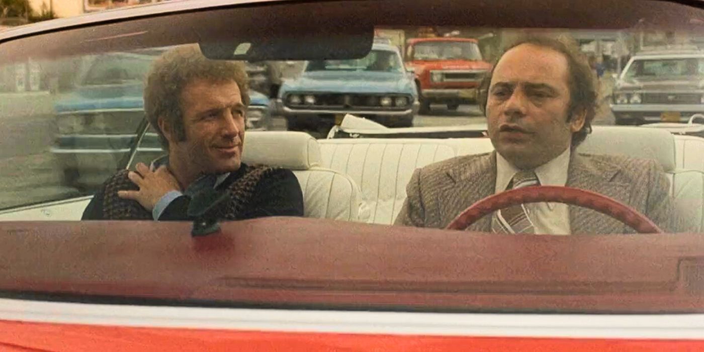 James Caan sitting in the passenger seat looking at Burt Young who is driving in The Gambler (1974)