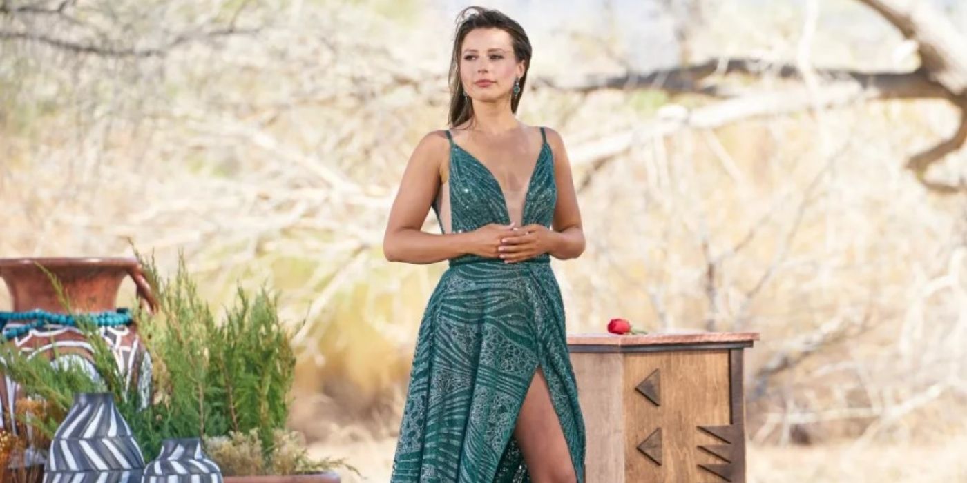 Katie Thurston stands in a green dress holding a rose in 'The Bachelorette' finale