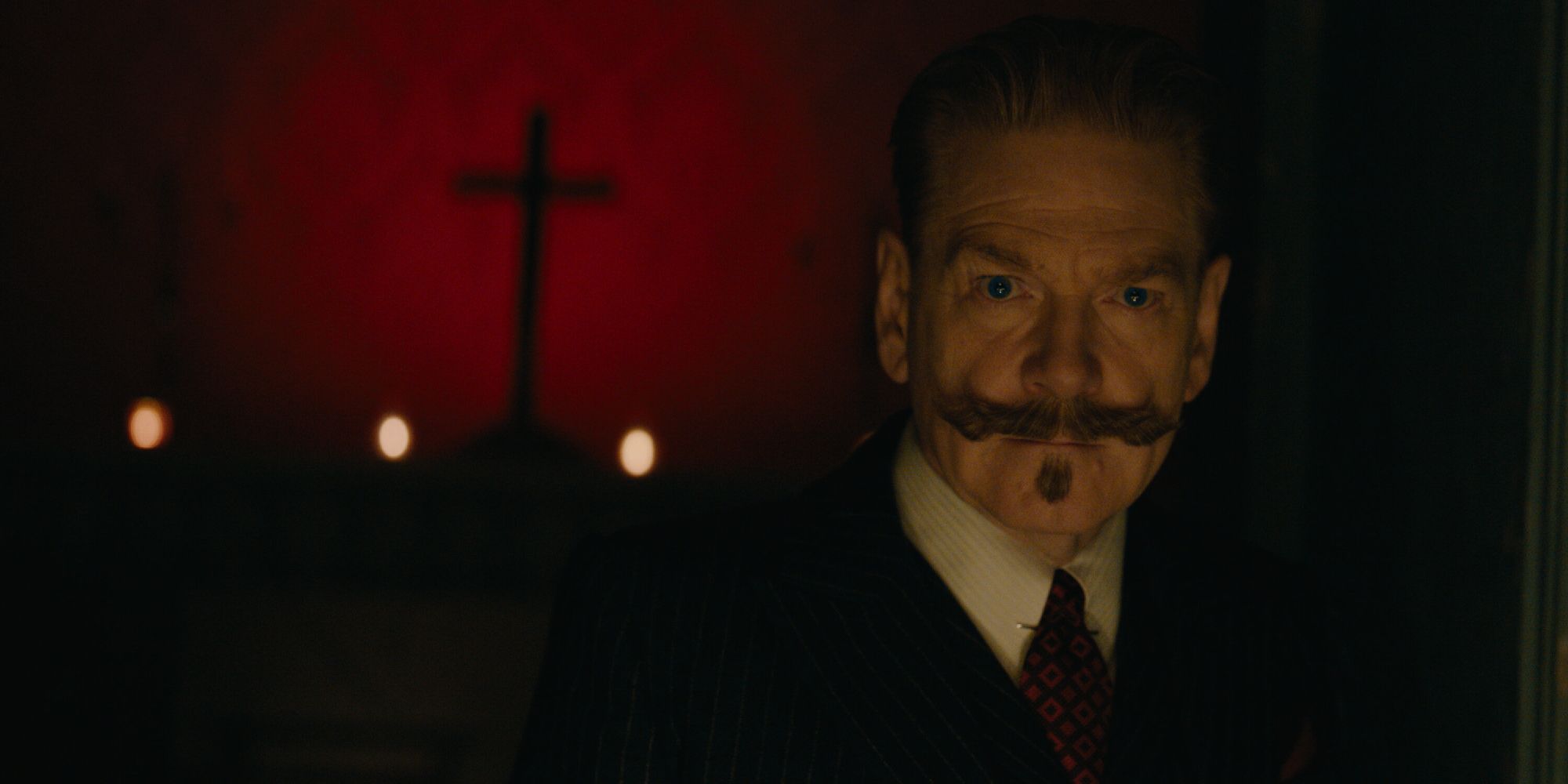 A close-up shot of Kenneth Branagh as Hercole Poirot in A Haunting in Venice.